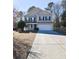 Two-story house with beige siding, white garage door, and a porch at 611 Resinwood Rd, Moncks Corner, SC 29461