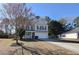 Two-story house with beige siding, white garage door, and a porch at 611 Resinwood Rd, Moncks Corner, SC 29461