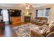 Living room with hardwood floors, fireplace, and large TV at 611 Resinwood Rd, Moncks Corner, SC 29461