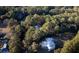 Aerial view of house nestled in lush trees, showcasing expansive property at 6124 Rudder Ln, Awendaw, SC 29429