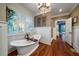 Spa-like bathroom with soaking tub, walk-in shower, and chandelier at 6124 Rudder Ln, Awendaw, SC 29429