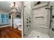 Luxurious bathroom with walk-in shower, soaking tub, and chandelier at 6124 Rudder Ln, Awendaw, SC 29429