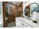 Bathroom with walk-in shower, white vanity and wood tile at 6124 Rudder Ln, Awendaw, SC 29429