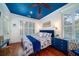 Bedroom with blue ceiling, king bed, and blue and white bedding at 6124 Rudder Ln, Awendaw, SC 29429