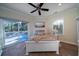 Bedroom with white bed, access to deck, and ceiling fan at 6124 Rudder Ln, Awendaw, SC 29429
