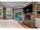 Main bedroom with fireplace, pool view, and built-in shelving at 6124 Rudder Ln, Awendaw, SC 29429
