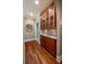 Butlers pantry with wood cabinetry, granite countertop and hardwood floors at 6124 Rudder Ln, Awendaw, SC 29429