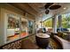 Relaxing covered porch with seating and fireplace at 6124 Rudder Ln, Awendaw, SC 29429