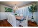 Bright dining room with hardwood floors, large windows, and a unique table at 6124 Rudder Ln, Awendaw, SC 29429