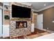 Elegant fireplace with built-in shelving and large TV at 6124 Rudder Ln, Awendaw, SC 29429