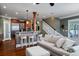 Gathering room with hardwood floors, a comfortable sofa, and a view of the kitchen at 6124 Rudder Ln, Awendaw, SC 29429