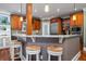 Kitchen island with seating, granite countertop, and a view of the Gathering room at 6124 Rudder Ln, Awendaw, SC 29429