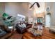 Spacious living room with hardwood floors, a large sofa, and a view into the dining area at 6124 Rudder Ln, Awendaw, SC 29429