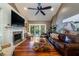 Spacious living room with fireplace, hardwood floors, and large TV at 6124 Rudder Ln, Awendaw, SC 29429