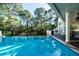 Stunning infinity pool with tranquil wooded backdrop at 6124 Rudder Ln, Awendaw, SC 29429
