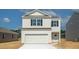 Two-story house with white siding, black shutters, and a white garage door at 730 Long Bluff Rd, Summerville, SC 29486