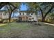 Large backyard with mature trees and screened porch at 8517 Falling Leaf Ln, North Charleston, SC 29420