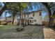 Spacious backyard with mature trees and screened porch at 8517 Falling Leaf Ln, North Charleston, SC 29420