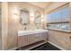 Double vanity bathroom with quartz countertop, neutral walls, and black tile floors at 8517 Falling Leaf Ln, North Charleston, SC 29420