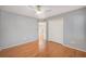 Simple bedroom with hardwood floors, ceiling fan, and access to upper level at 8517 Falling Leaf Ln, North Charleston, SC 29420