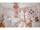 Charming bedroom with floral wall mural, chandelier, and ample natural light at 8517 Falling Leaf Ln, North Charleston, SC 29420