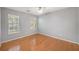 Spacious bedroom with hardwood floors and two large windows at 8517 Falling Leaf Ln, North Charleston, SC 29420