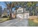 Two-story house with a two-car garage and mature trees at 8517 Falling Leaf Ln, North Charleston, SC 29420