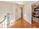 Upstairs hallway with hardwood floors and access to bedrooms at 8517 Falling Leaf Ln, North Charleston, SC 29420