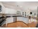 Open concept kitchen boasts white cabinets, granite countertops, and stainless steel appliances at 8517 Falling Leaf Ln, North Charleston, SC 29420