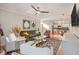 Open concept living room with kitchen view and a green sofa at 8517 Falling Leaf Ln, North Charleston, SC 29420