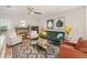 Cozy living room with fireplace, green sofa and hardwood floors at 8517 Falling Leaf Ln, North Charleston, SC 29420