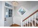 Bright entryway with hardwood floors, staircase and stained glass at 95 Fishburne St, Charleston, SC 29403