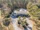 Aerial view of a ranch home with circular driveway and lush landscaping at 1081 Saint Thomas Island Dr, Charleston, SC 29492