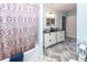 Bathroom with double vanity, black countertop, and patterned shower curtain at 1081 Saint Thomas Island Dr, Charleston, SC 29492