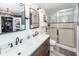 Bathroom with double vanity, walk-in shower, and stylish tile flooring at 1081 Saint Thomas Island Dr, Charleston, SC 29492