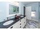 Light blue bathroom with double vanity and black countertop at 1081 Saint Thomas Island Dr, Charleston, SC 29492