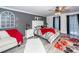 Primary bedroom with a gray wall and red bedding at 1081 Saint Thomas Island Dr, Charleston, SC 29492