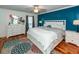 Bedroom with a king-size bed, teal accent wall and hardwood floors at 1081 Saint Thomas Island Dr, Charleston, SC 29492