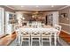 White farmhouse dining table with six chairs in a bright dining room with hardwood floors at 1081 Saint Thomas Island Dr, Charleston, SC 29492