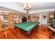 Game room features a ping pong table, hardwood floors, and built-in shelving at 1081 Saint Thomas Island Dr, Charleston, SC 29492