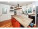 Kitchen features a butcher block island, white cabinets and red base, and stainless steel appliances at 1081 Saint Thomas Island Dr, Charleston, SC 29492