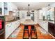 Kitchen boasts butcher block island, white cabinets, granite counters, and stainless steel appliances at 1081 Saint Thomas Island Dr, Charleston, SC 29492
