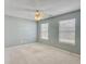 Bright bedroom with neutral walls, plush carpeting, and two large windows at 173 Hainsworth Dr, North Charleston, SC 29418