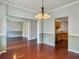 Bright dining room with hardwood floors and chandelier, open to kitchen and living room at 173 Hainsworth Dr, North Charleston, SC 29418