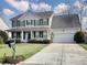 Two-story house with green shutters, white siding, and a two-car garage at 173 Hainsworth Dr, North Charleston, SC 29418