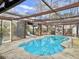 Enclosed kidney-shaped pool with covered patio and fireplace at 173 Hainsworth Dr, North Charleston, SC 29418