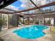 Screened-in pool with pergola and stone fireplace at 173 Hainsworth Dr, North Charleston, SC 29418