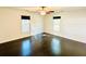 Bright bedroom with dark hardwood floors and two windows at 1966 Suzanne St, Johns Island, SC 29455