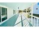 Long, covered porch with white railings and light teal flooring at 1966 Suzanne St, Johns Island, SC 29455