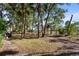 Landscaped backyard with mature trees and grassy areas at 2942 Seabrook Island Rd, Seabrook Island, SC 29455